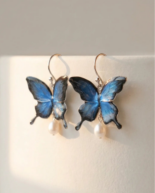 Sparkling Made petite blue shimmer butterfly pearl earrings featuring a soft shimmer finish and pearl drop