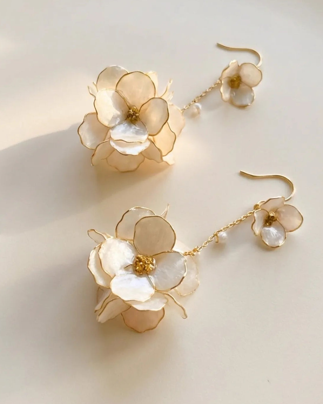 Sparkling Made large flower dangle earrings with pearl shine highlighting petal texture and handcrafted wire details